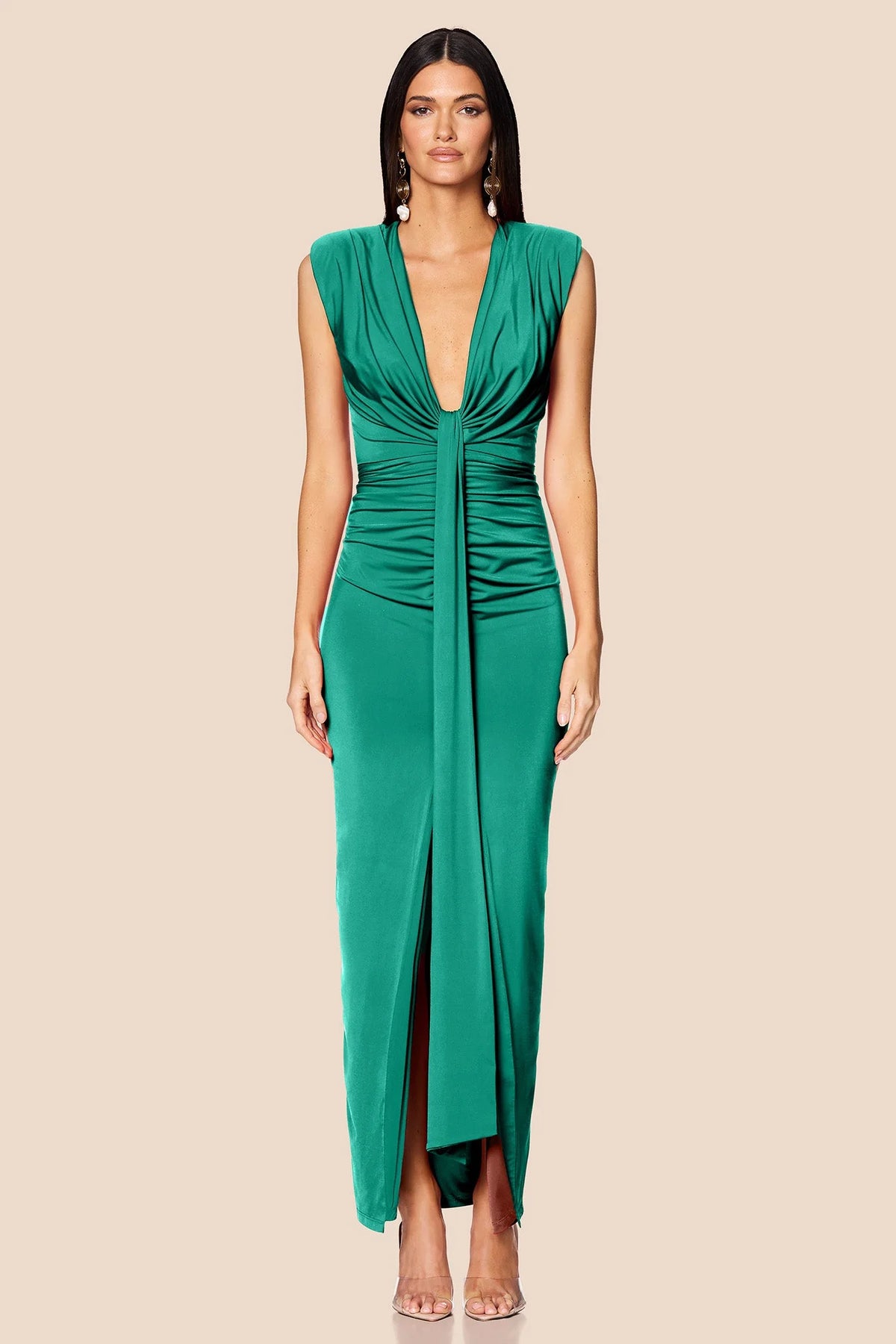 Woman wearing a green dress on a beige background